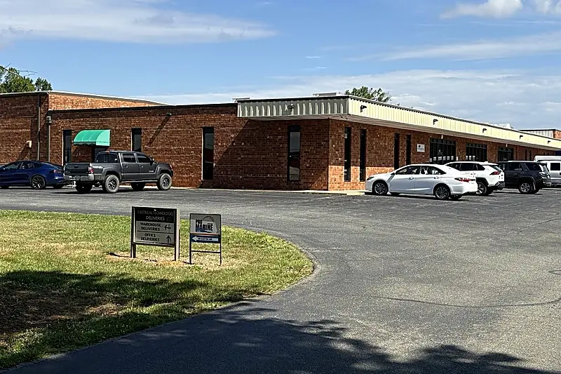 One-story brick flex building with an office entrance and parking, Burlington, North Carolina.