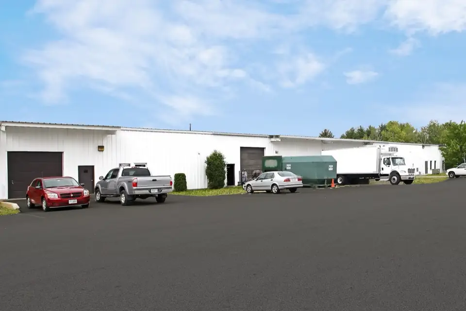 White small-bay industrial building with a row of overhead doors, Concord, New Hampshire.