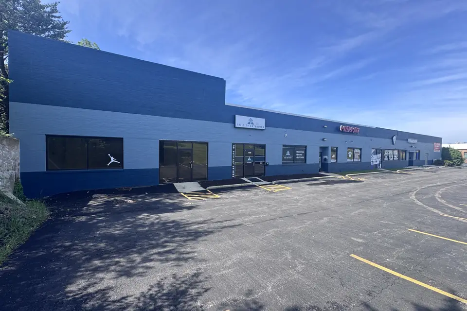 Long one-story flex building with storefronts and a parking lot, St. Charles, Illinois.